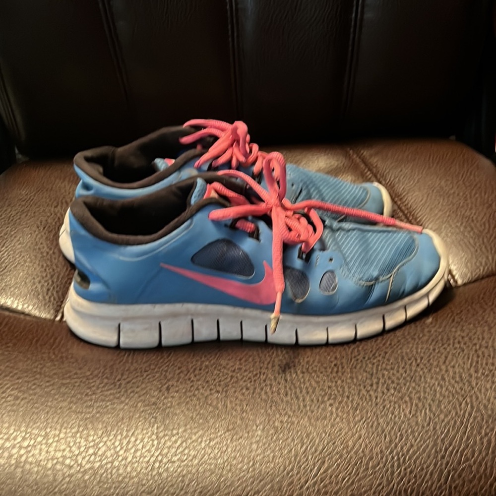 Blue and pink Nike free runs